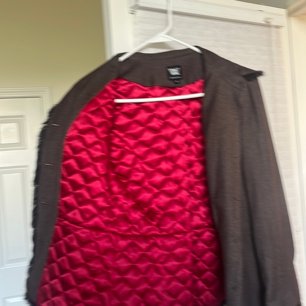 Brown jacket lined in red. Trimmed with fur.